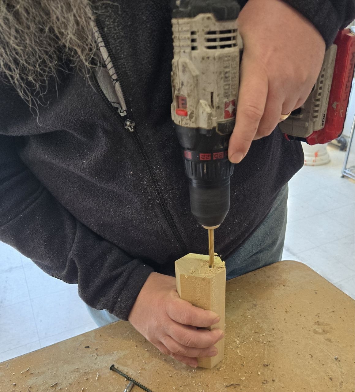 Drilling nesting holes into a wood block for the bee hotel