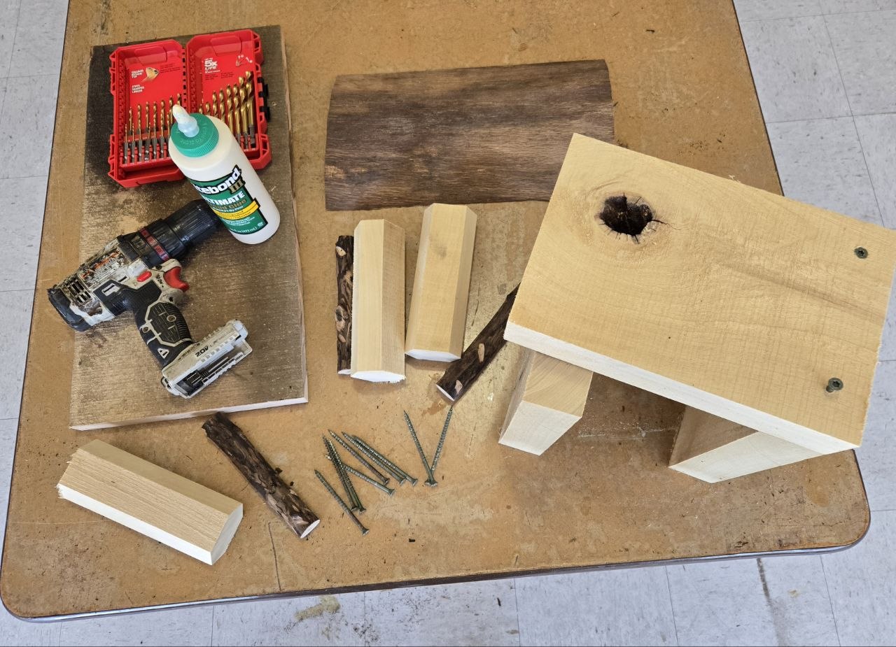 Materials and tools laid out for the rustic bee hotel build