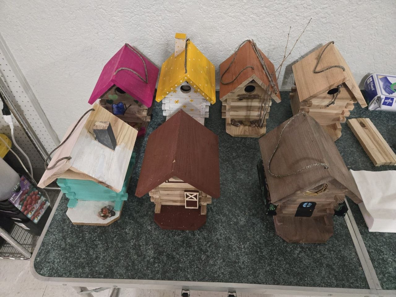 Finished cedar birdhouses lined up together