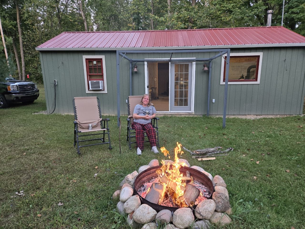 Vanessa outside by the cabin during a later-season bonfire as they stretched out the fall season