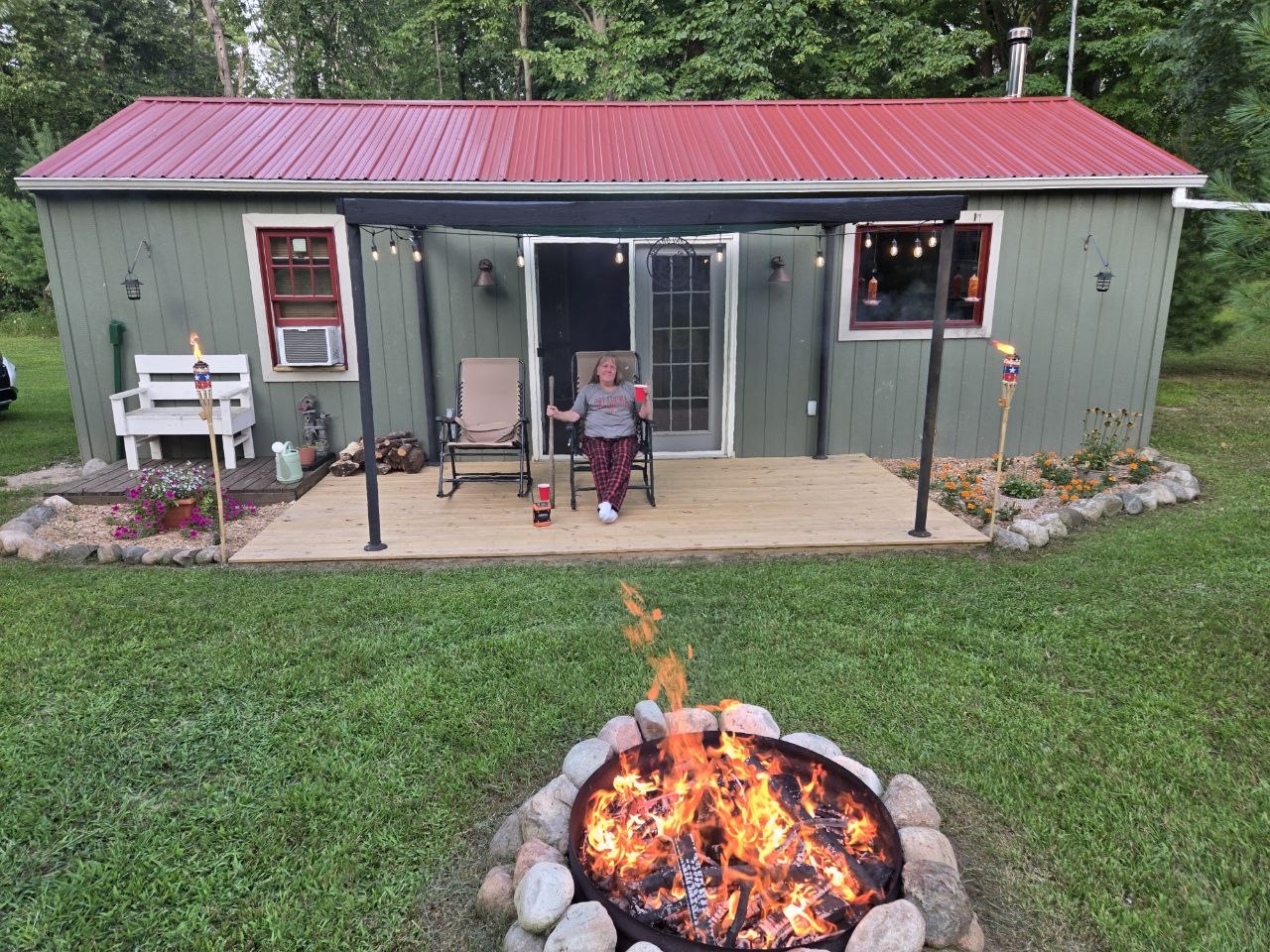 Evening bonfire scene in front of the cabin during the August 2025 reunion stretch