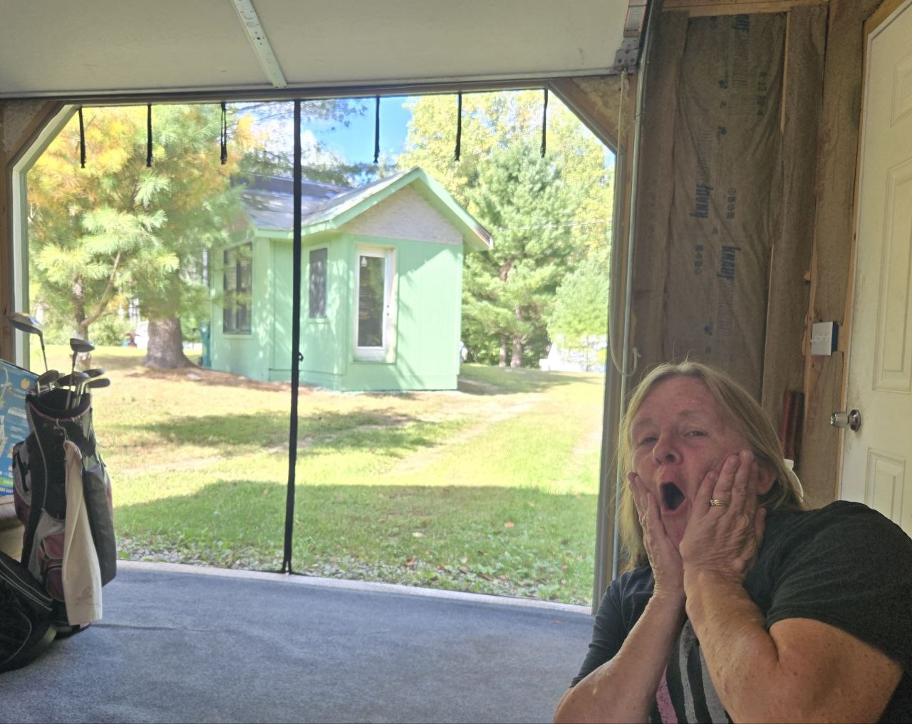 Vanessa reacting to the surprise of how the freshly painted structure ended up looking