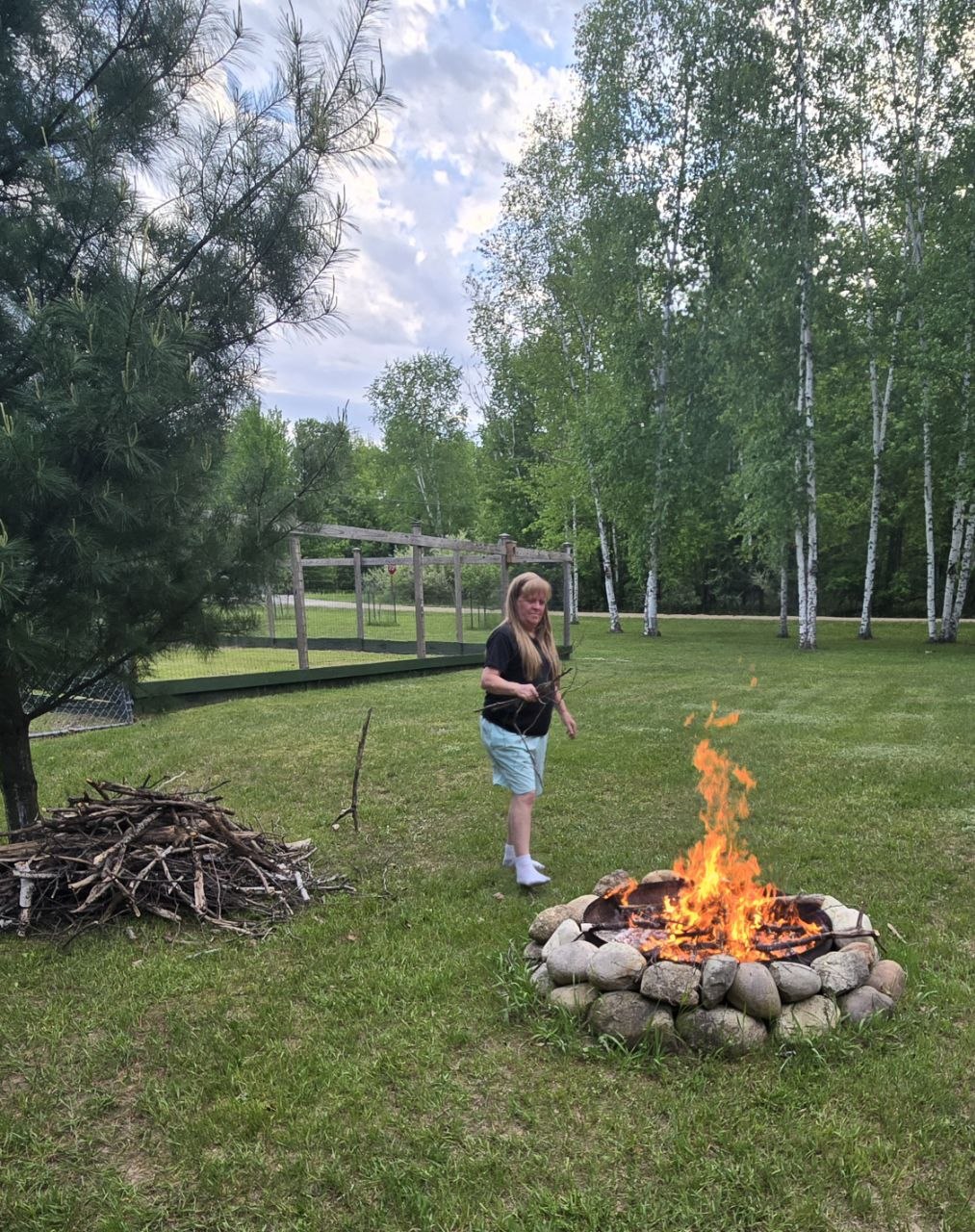 Evening bonfire beside the cabin after a long day of cleanup and projects in late May 2026