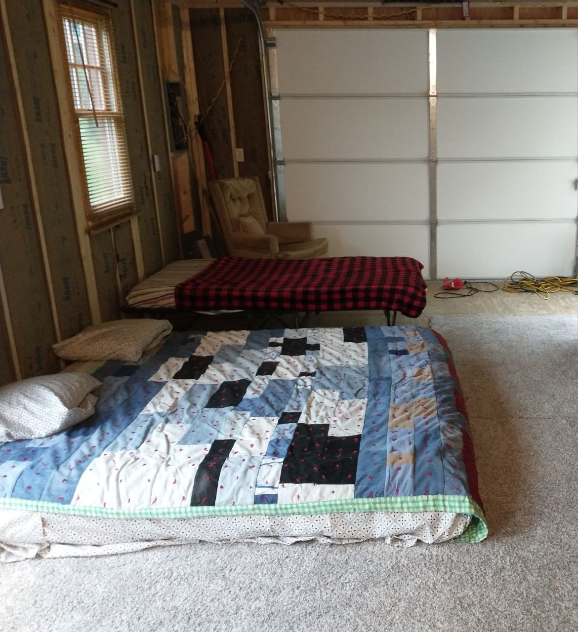 Simple sleeping setup inside the unfinished cabin during the early make-do stage