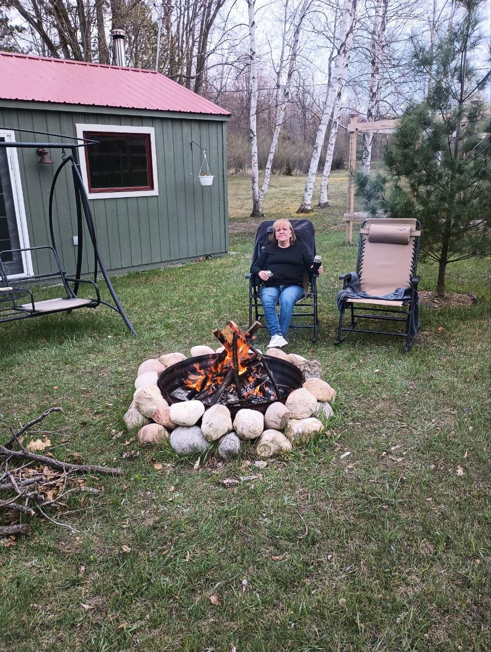 Cool spring bonfire day in April 2023 at the cabin using fallen winter branches